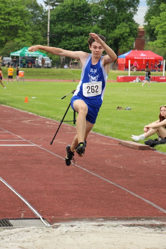 An OFA student performs the long jump.