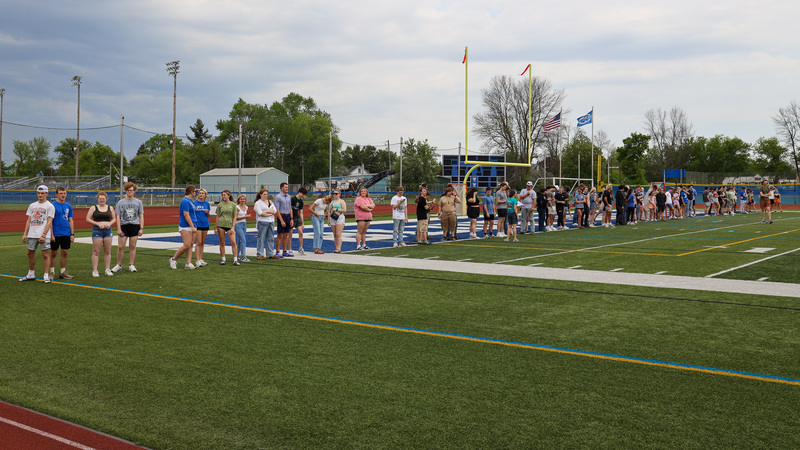 seniors stand in line on field