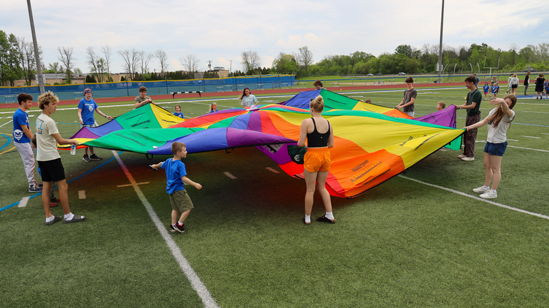 students playing with parachute