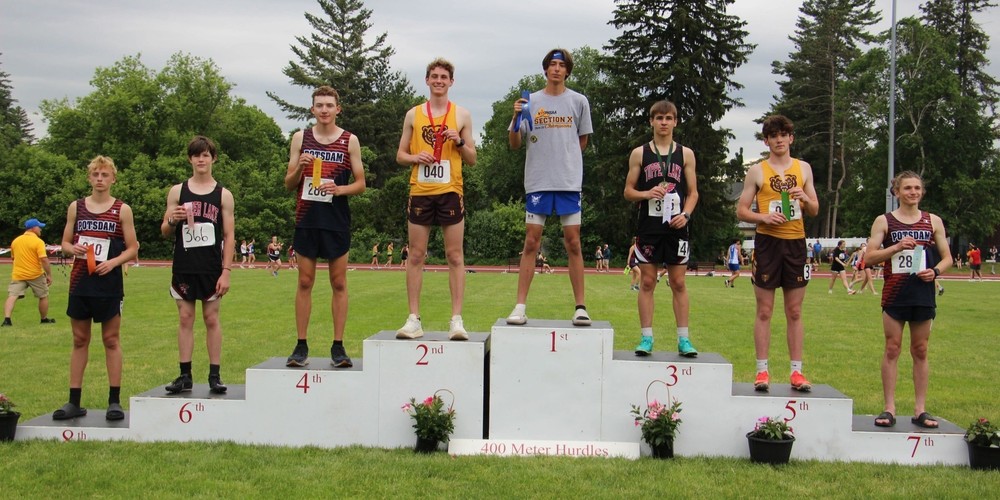 Gabe Peabody standing at the top of a podium