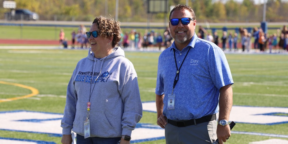 Christina Frank and Kevin Kendall standing on OFA turf football field