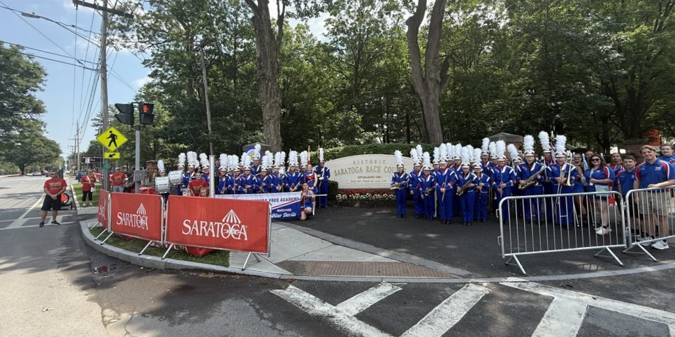 Marching band group photo in from of Saratoga Race Course entrance