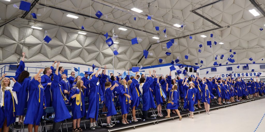 Students toss their caps in the air on graduation day.