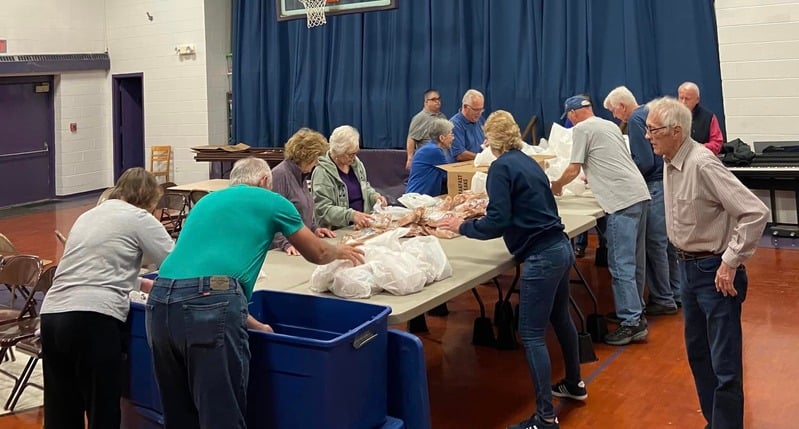 Snackpack program volunteers with bags of food.